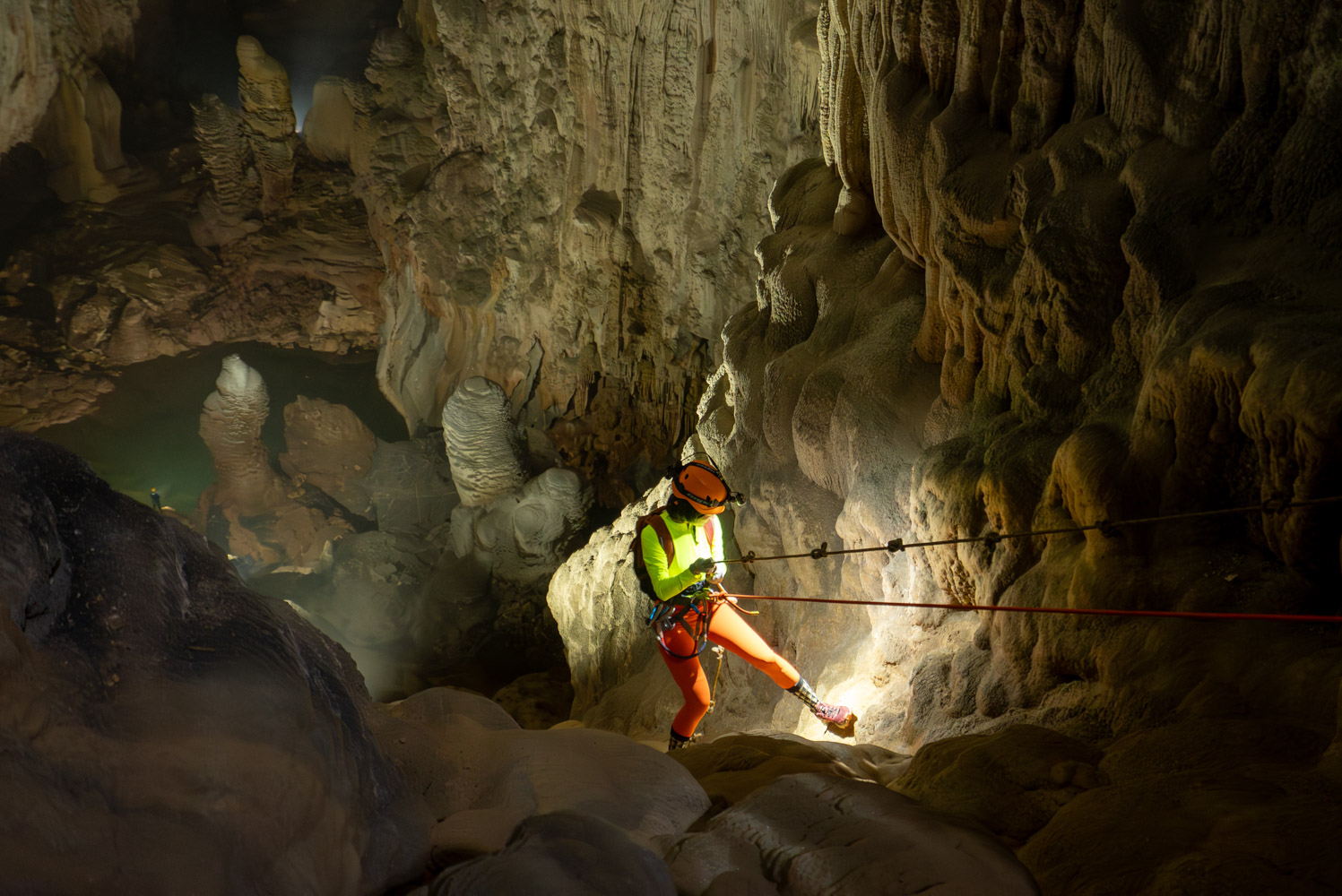 A caver with safety gear rappels into Song Doong cave. A caver with safety gear rappels into Song Doong cave.